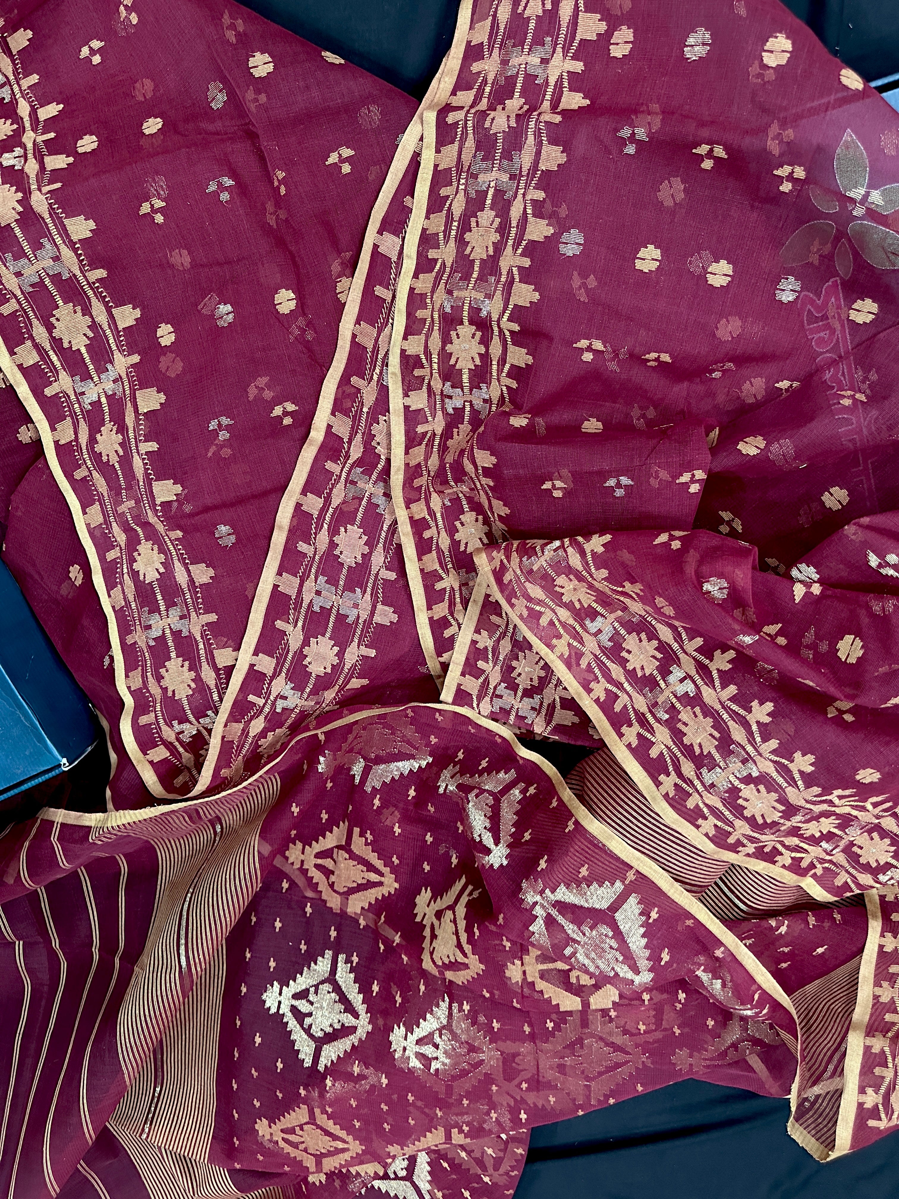 Maroon cotton jamdani with yellowish threads work.