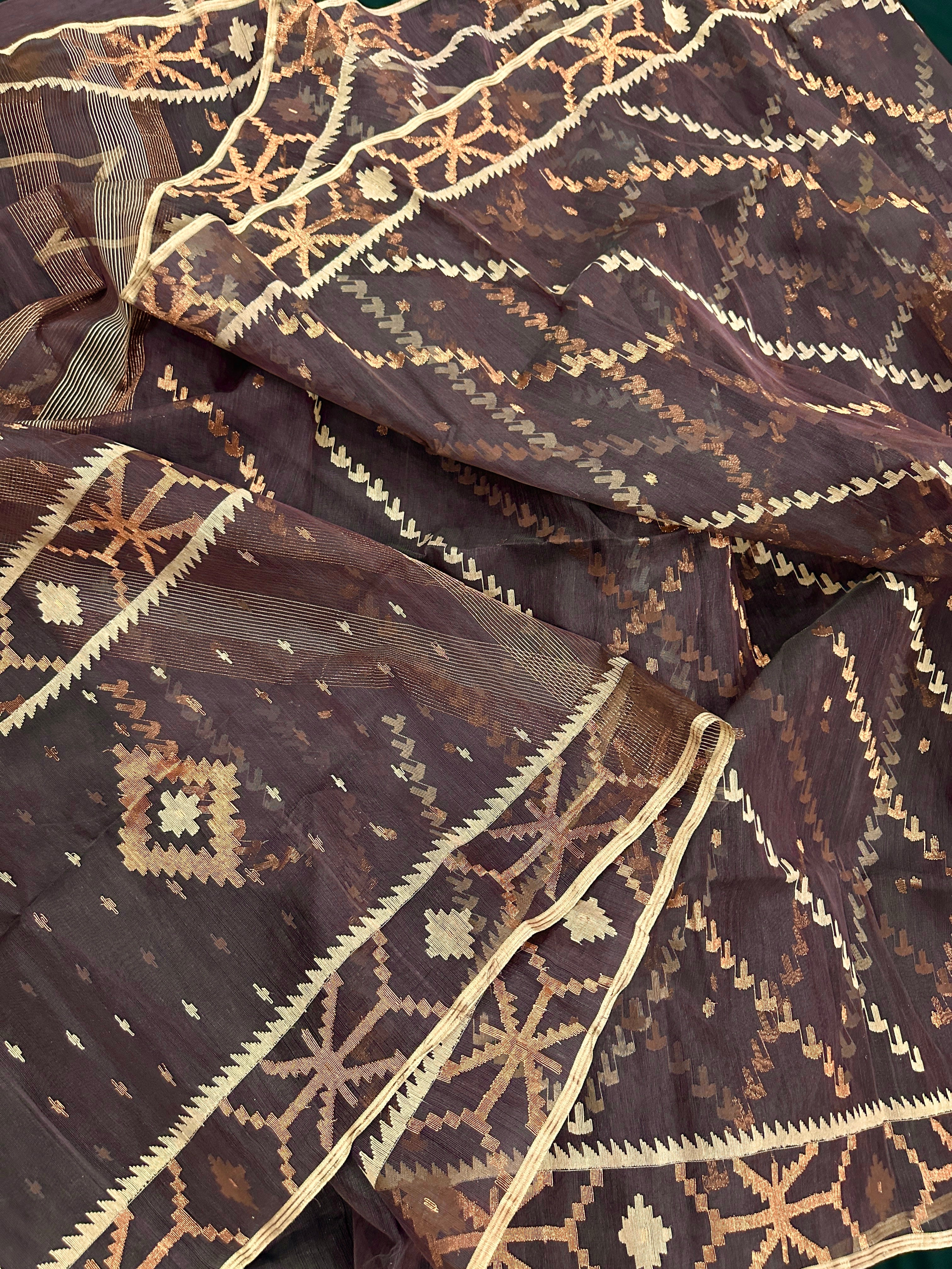Brown colour jamdani saree with brown & off white threads work.