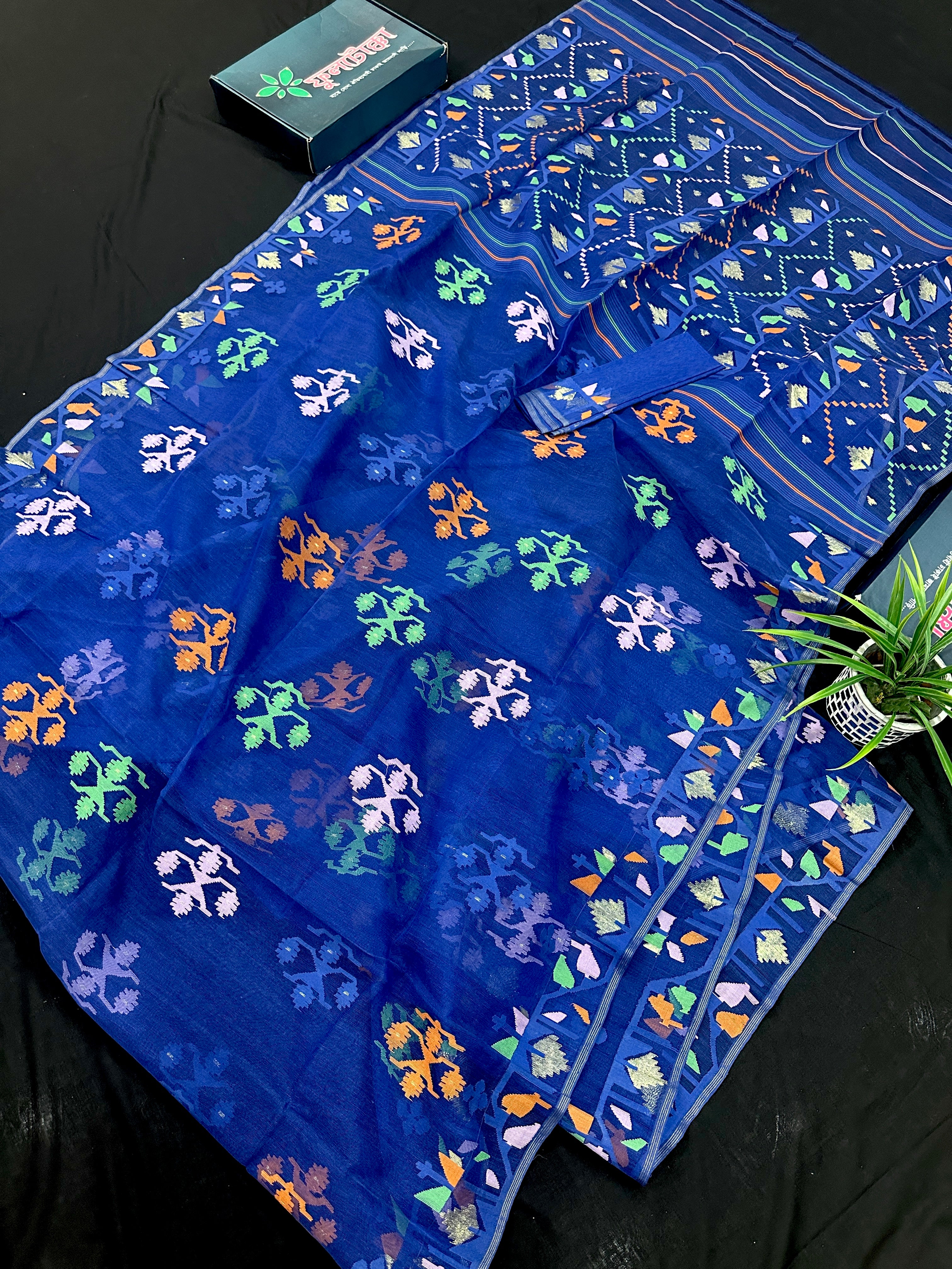 Royal blue jamdani saree with green pink blue orange threads work.