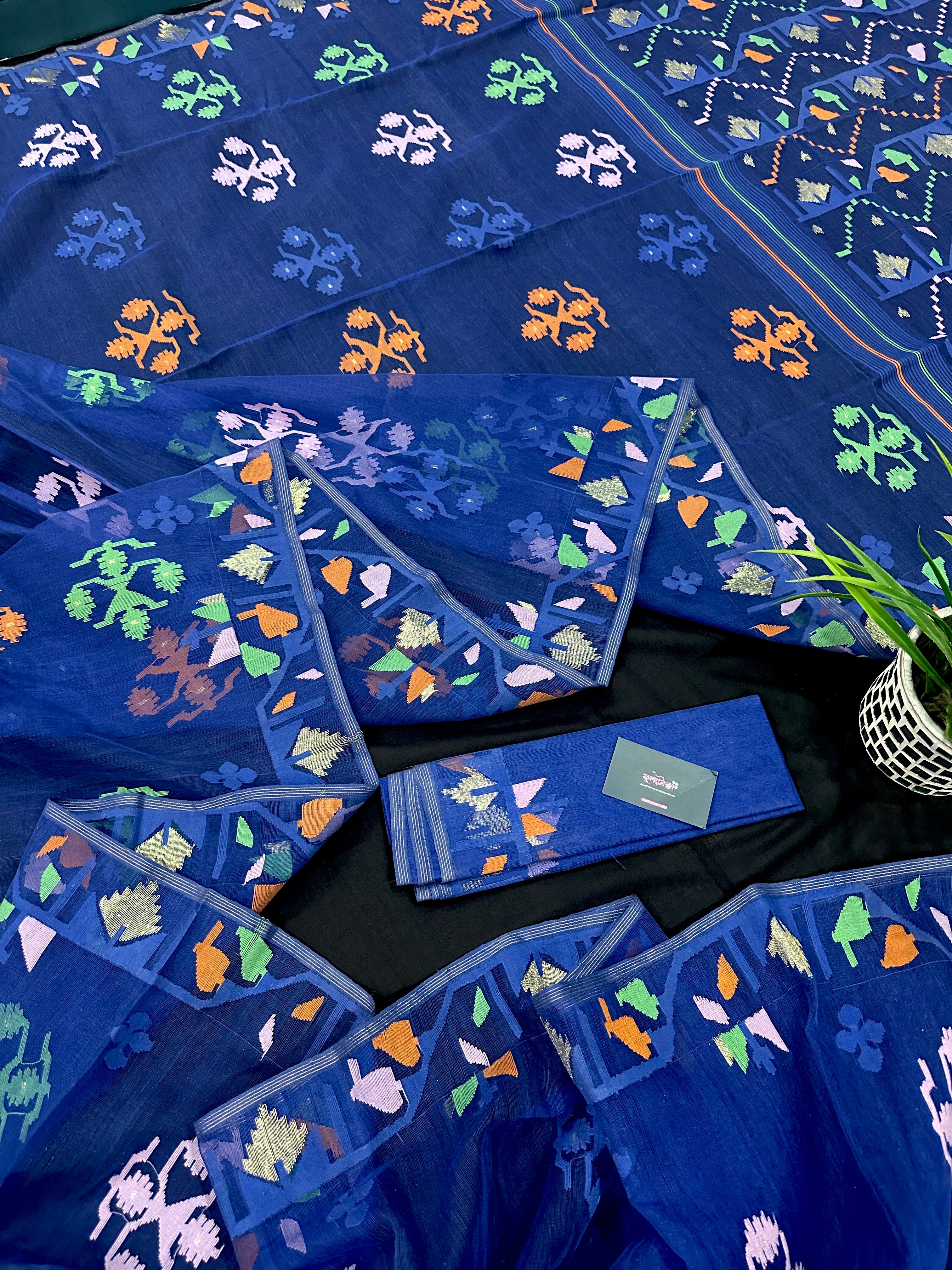 Royal blue jamdani saree with green pink blue orange threads work.