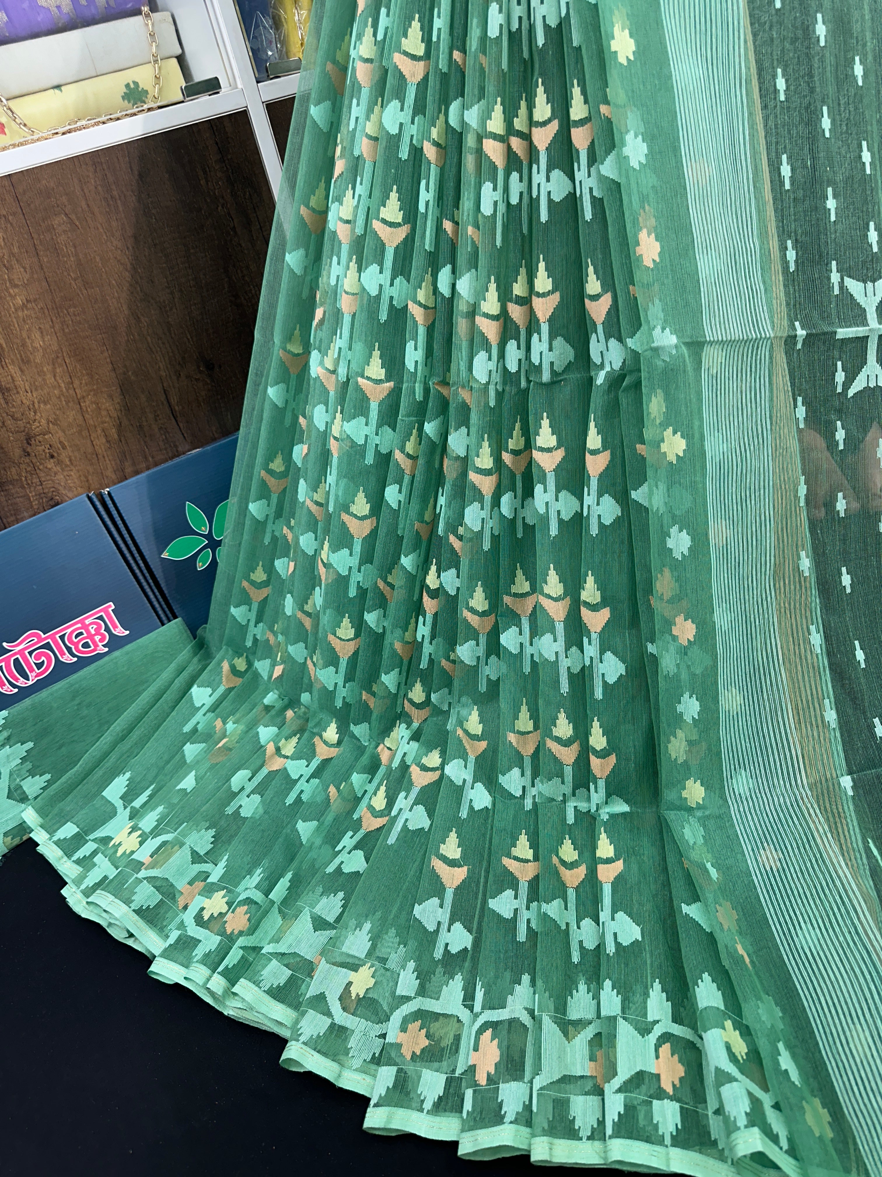 Jade green halfsilk jamdani saree with green off white golden self threads work