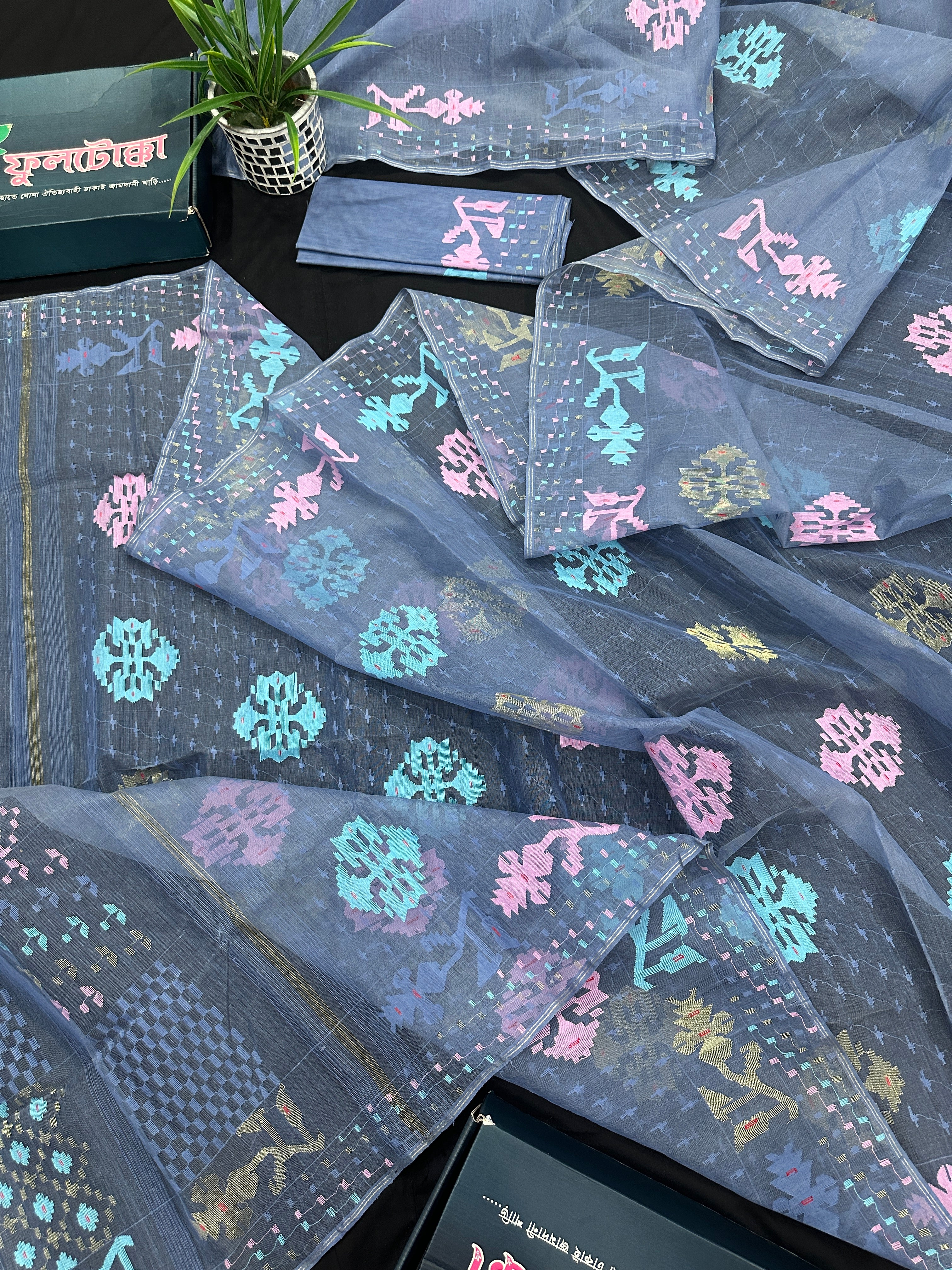 Powdery blue jamdani saree with pink blue and golden jori work.