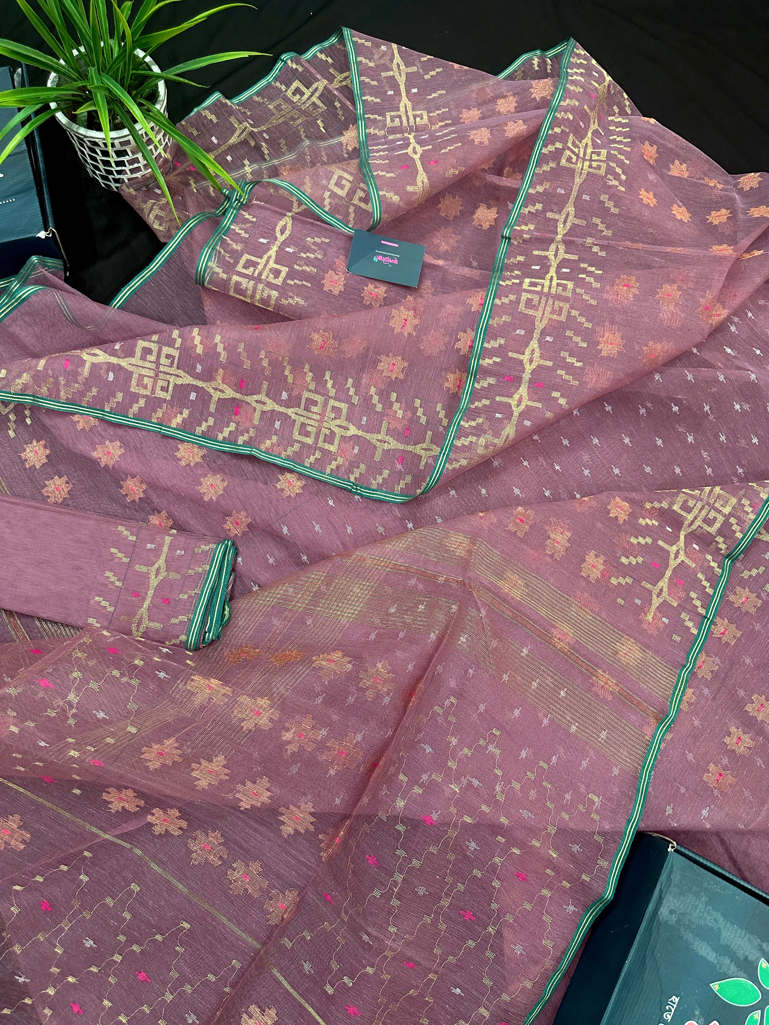 Onion colour jamdani saree with pink meena and green border.