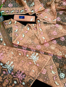 Creamy peach jamdani saree with pink white and peach threads work.