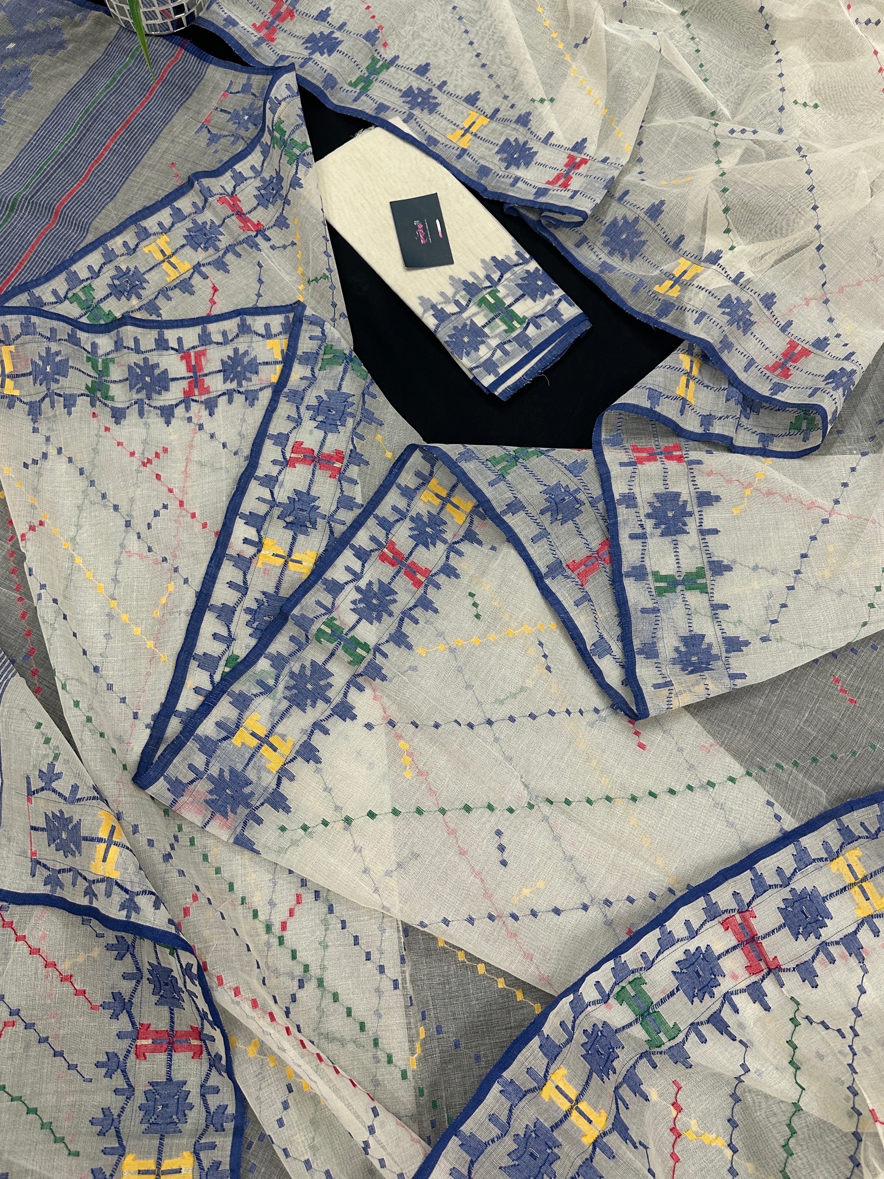 White cotton jamdani saree with blue yellow red green threads work& blouse piece.
