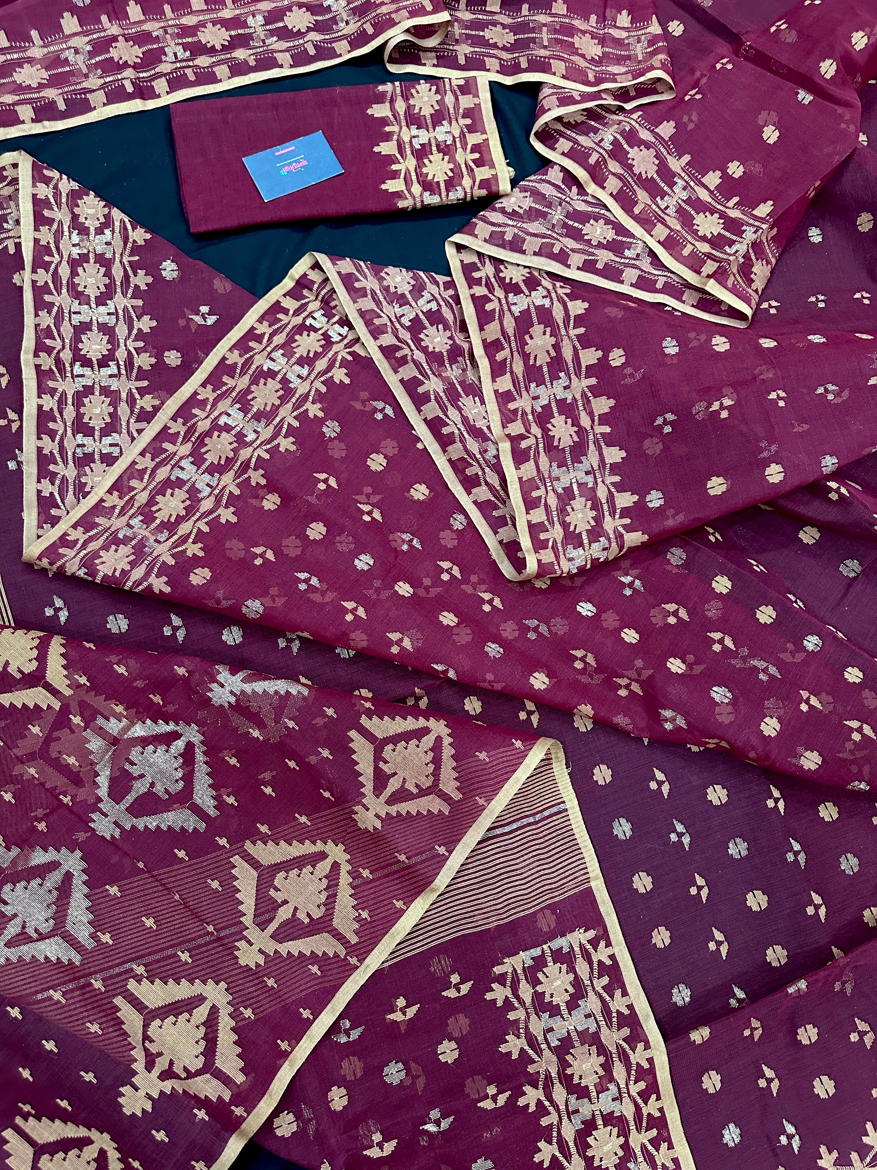 Maroon cotton jamdani with yellowish threads work.