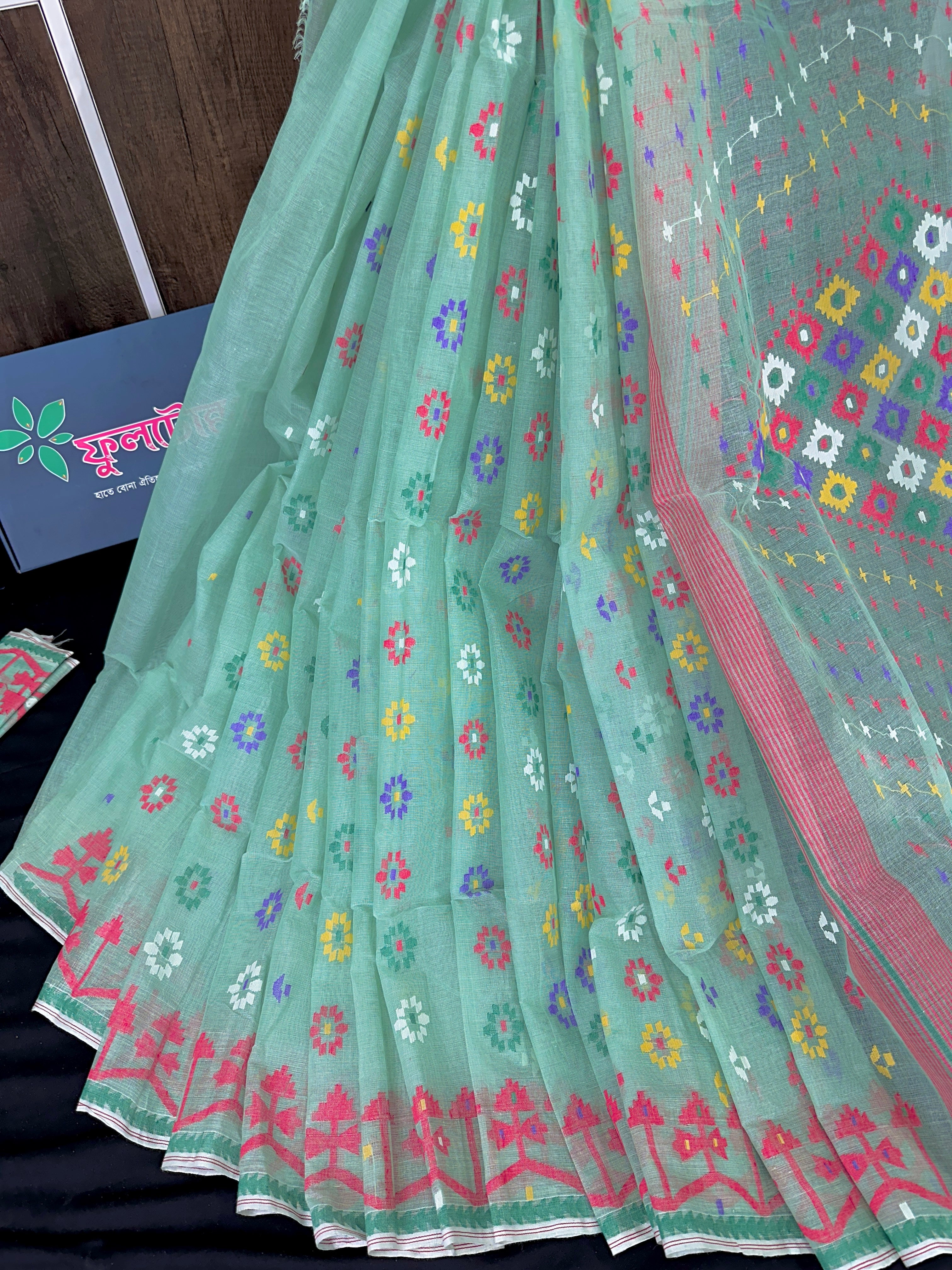 Mint cotton jamdani saree with yellow blue purple red white floral work.
