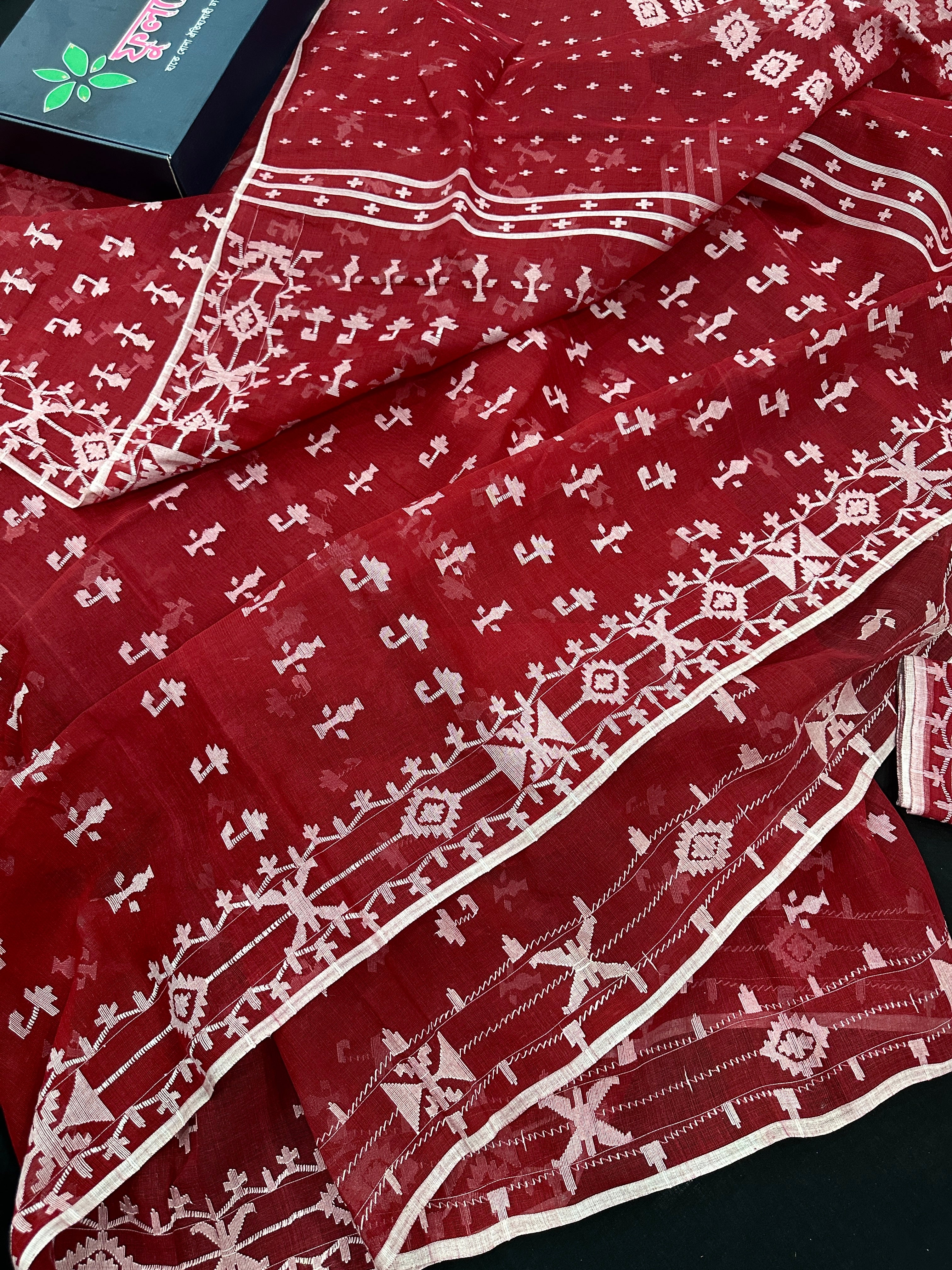 Maroon jamdani saree with white thread work.