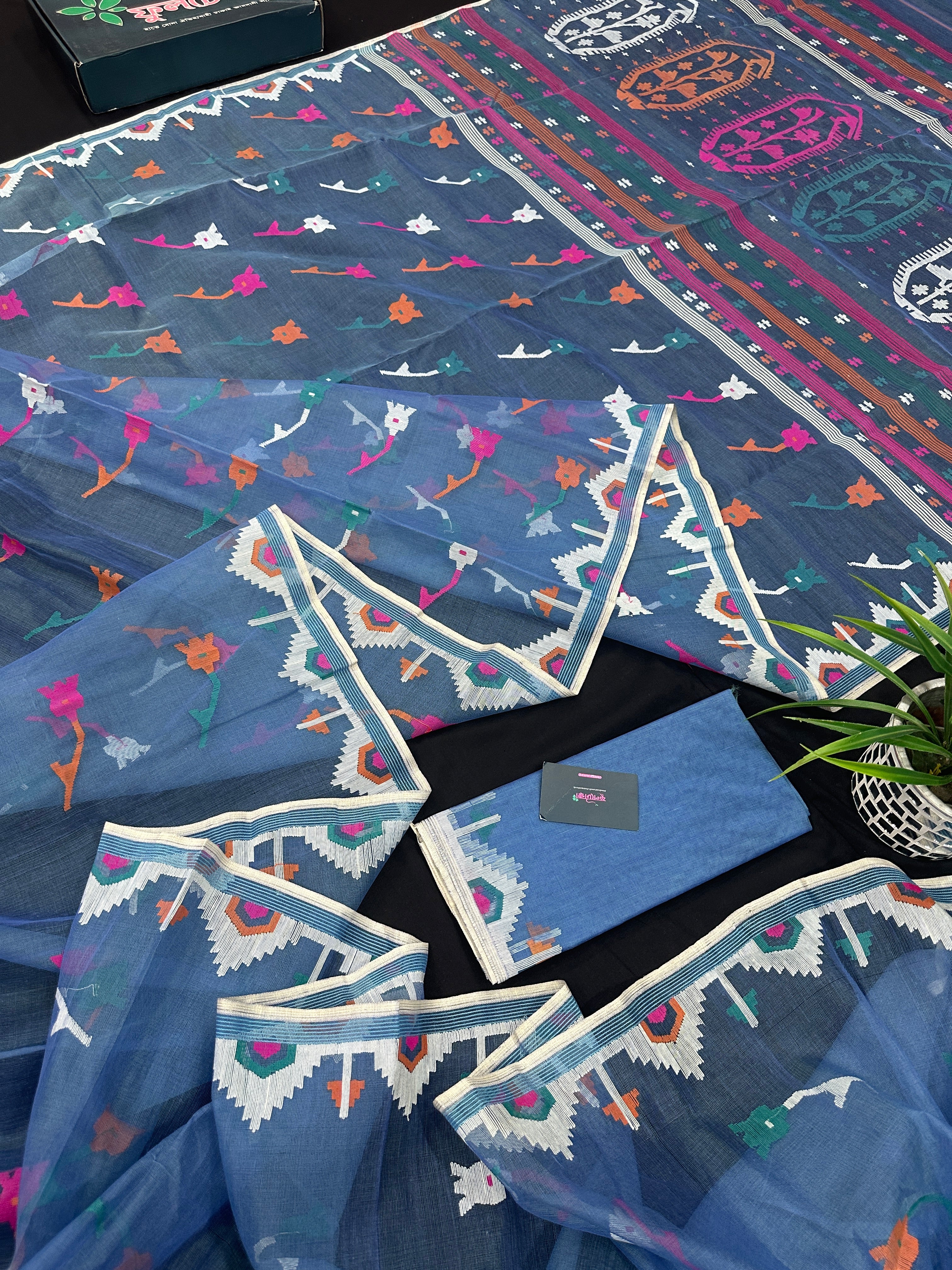 Dusty blue jamdani saree with pink white blue green work and white paar.