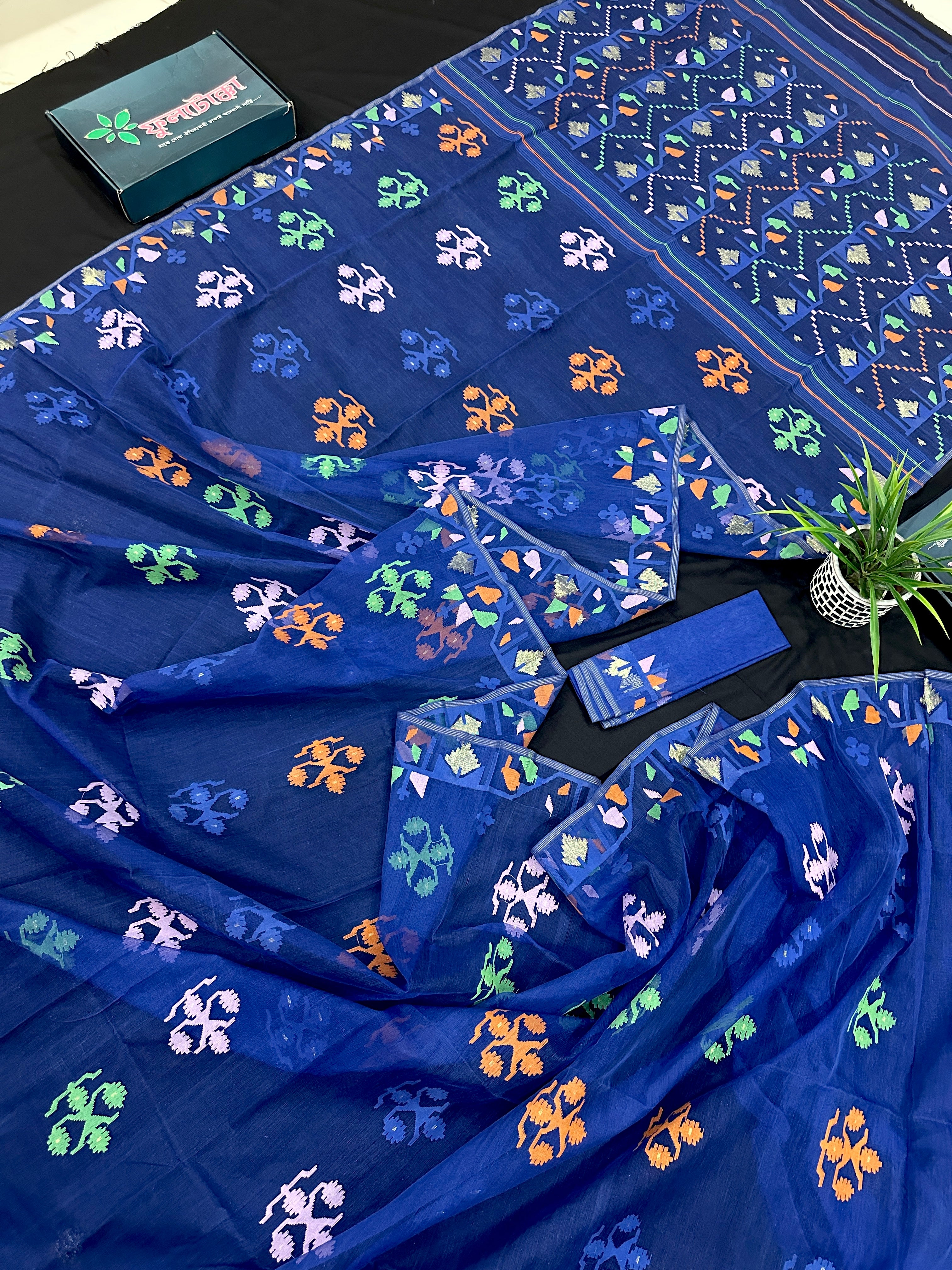 Royal blue jamdani saree with green pink blue orange threads work.