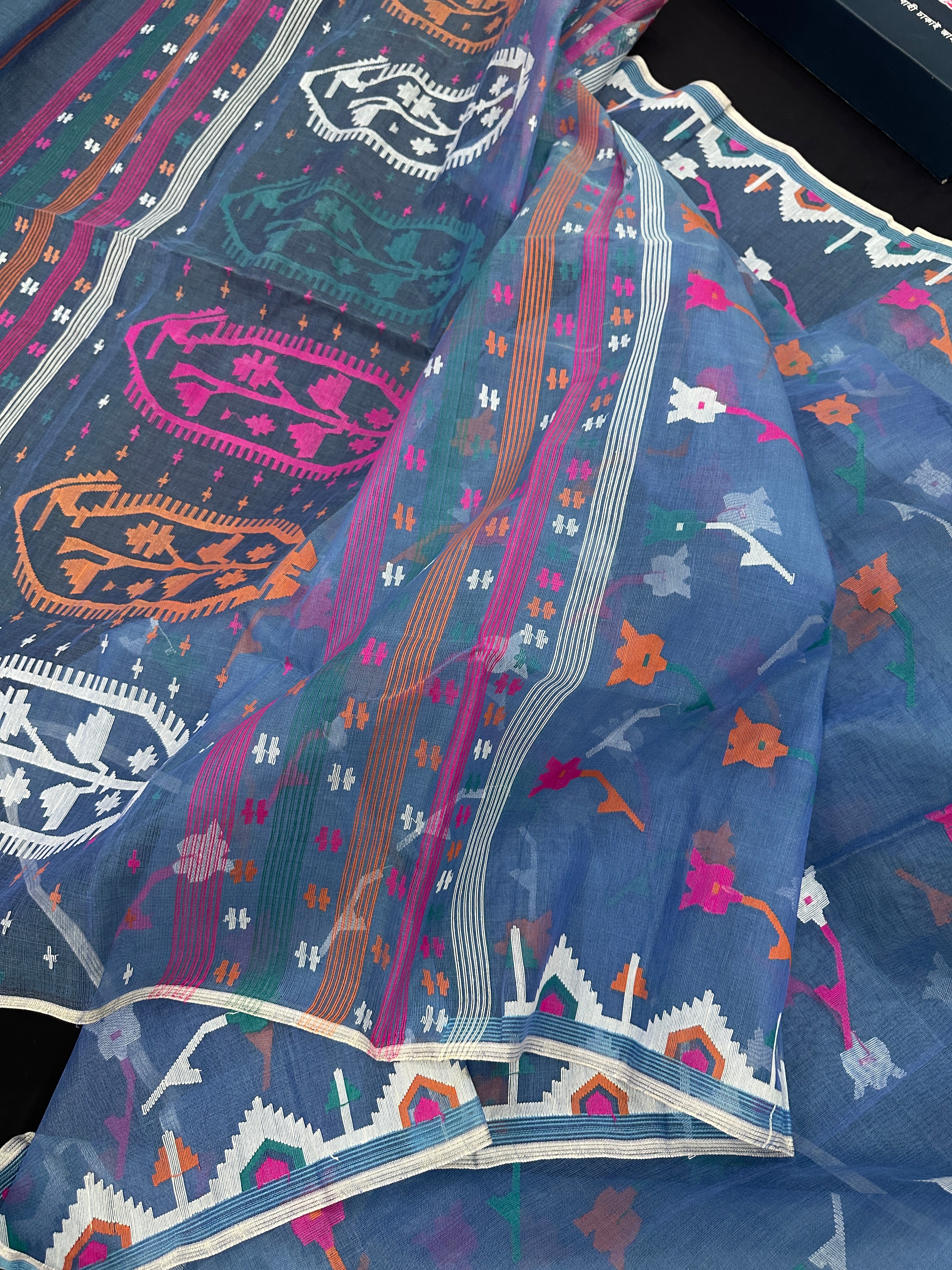 Dusty blue jamdani saree with pink white blue green work and white paar.