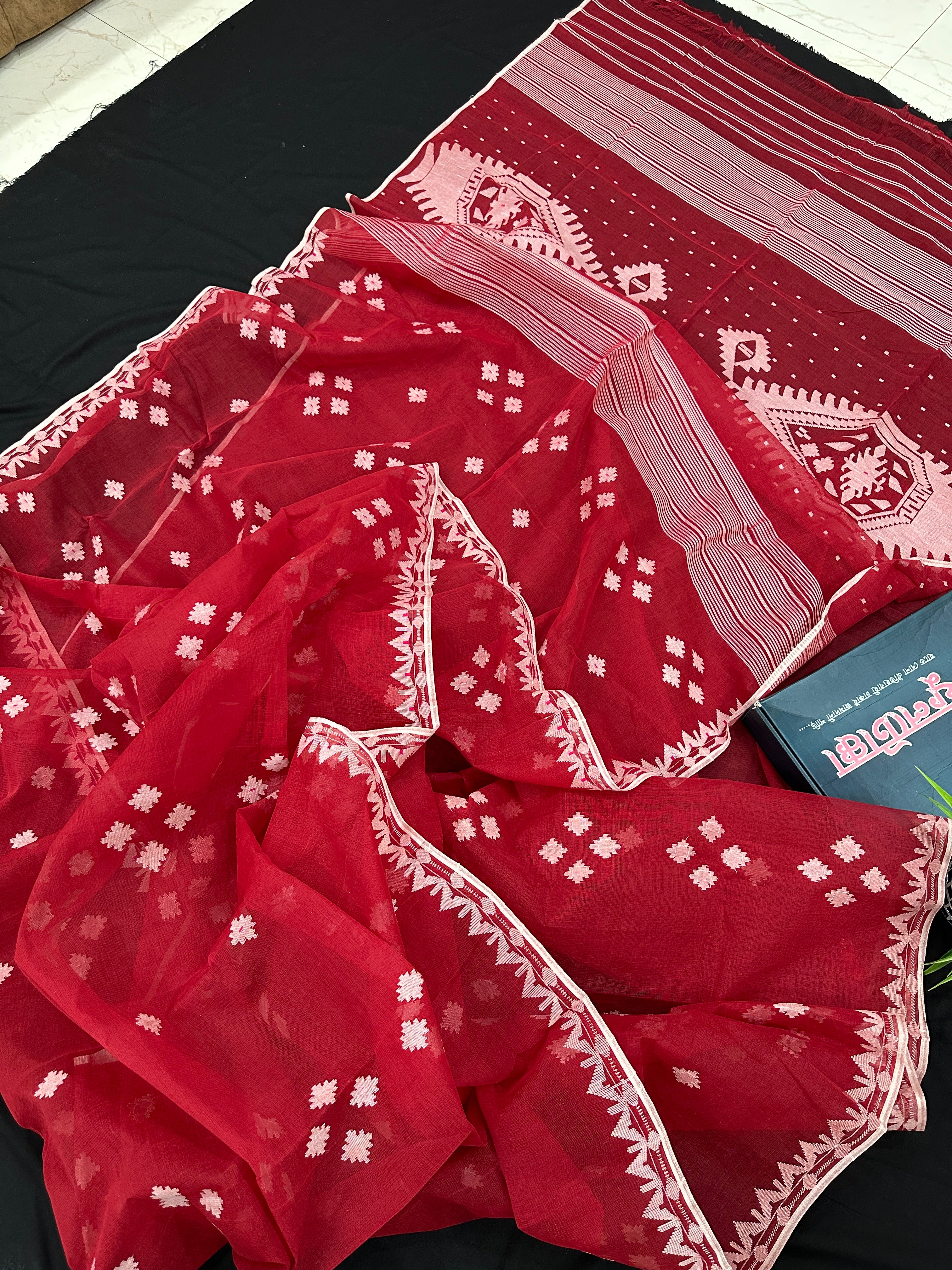 Radish Maroon cotton jamdani saree with white threads work all over work.