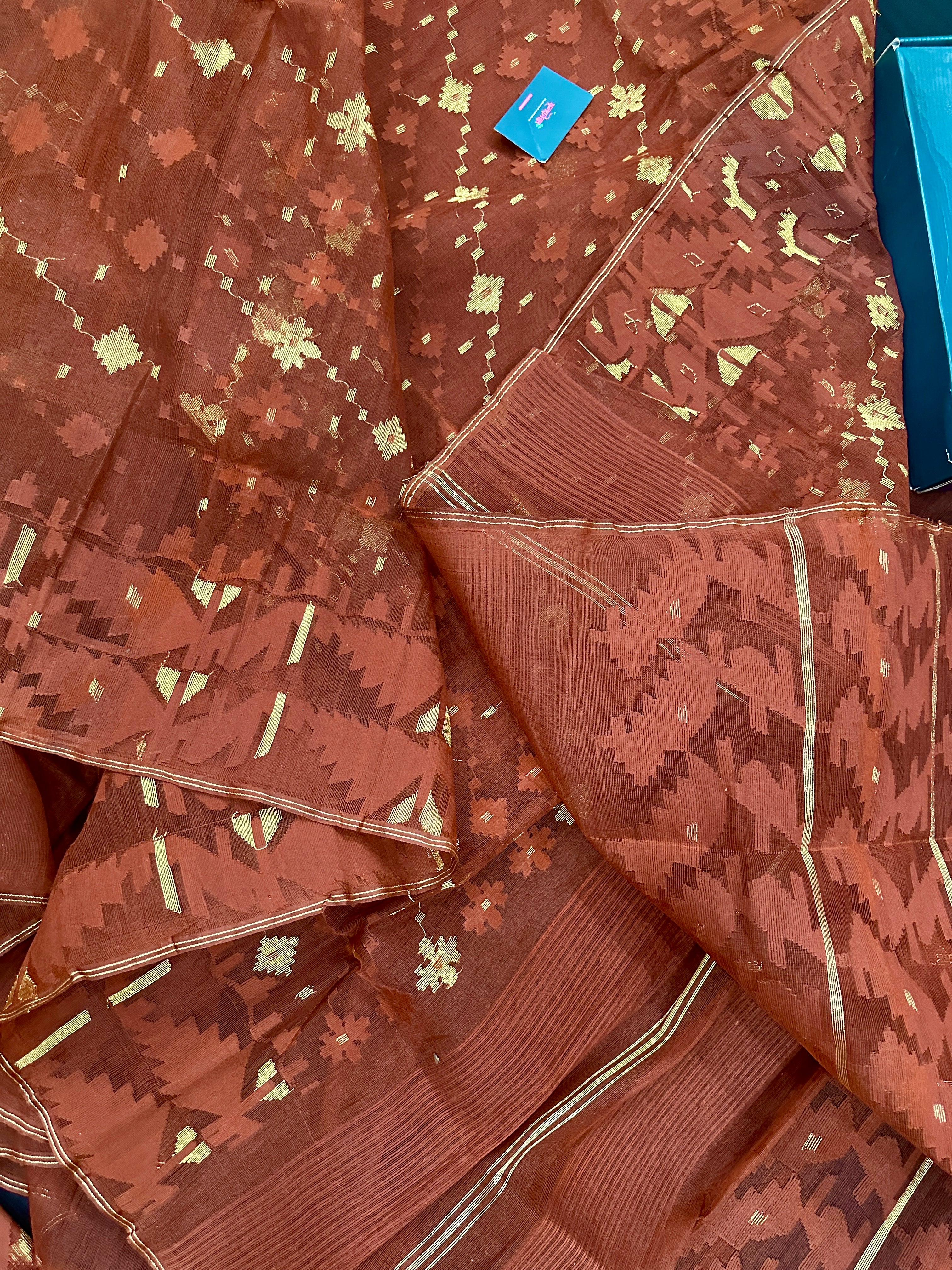 Mehendi brown jamdani saree with golden work.