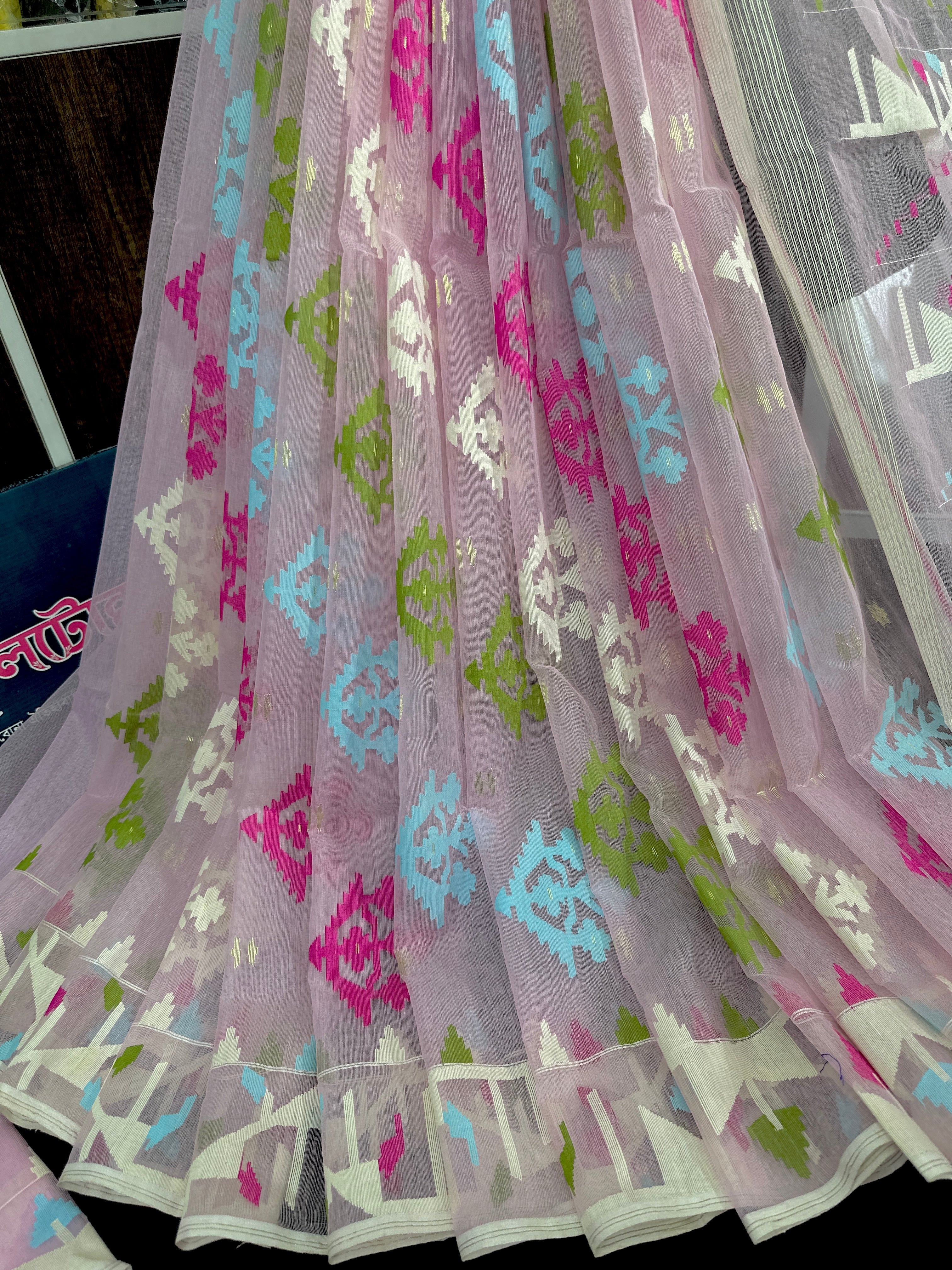 Baby pink halfsilk jamdani saree with blue magenta green off white threads work