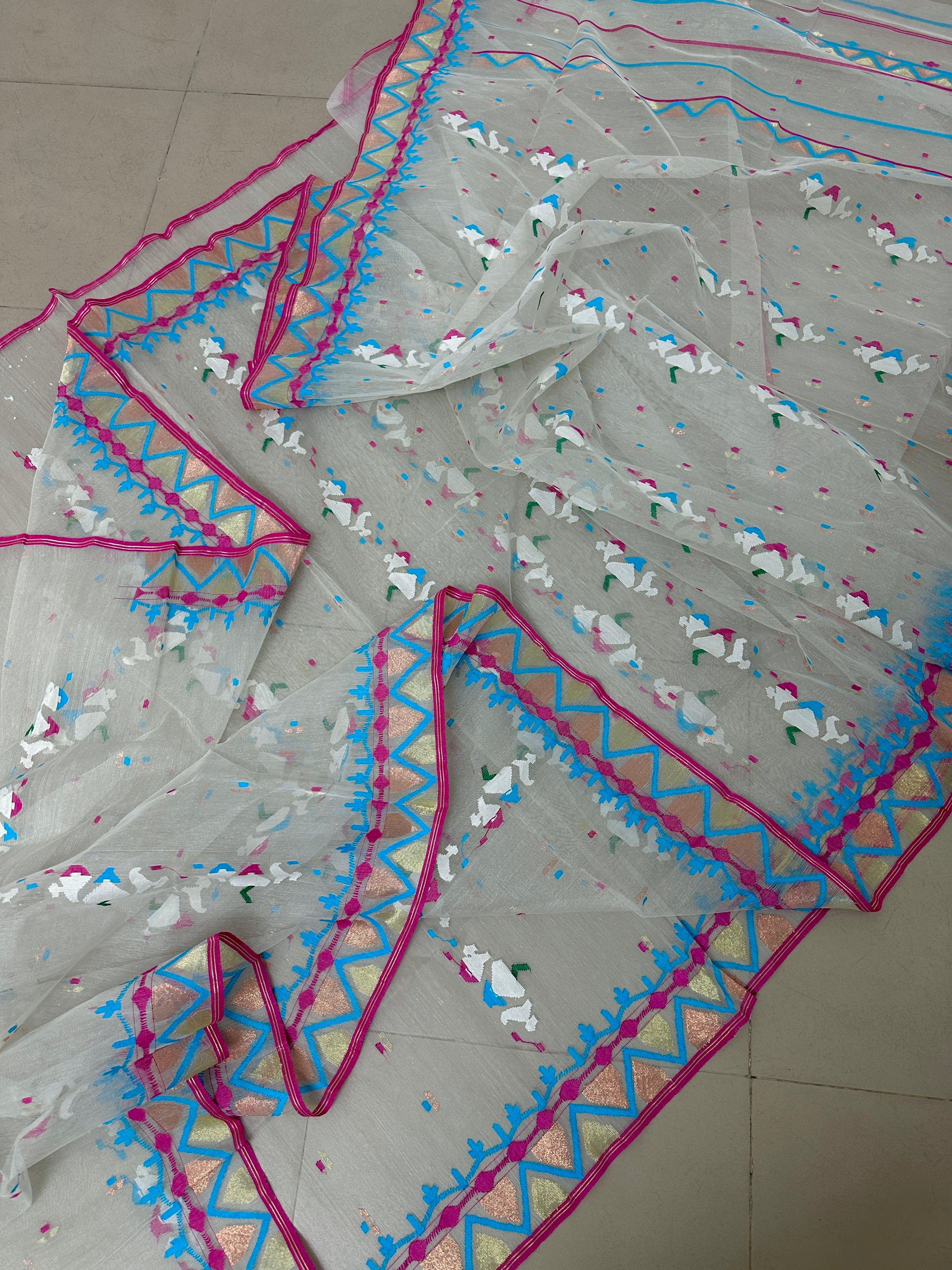 White jamdani with pink border.