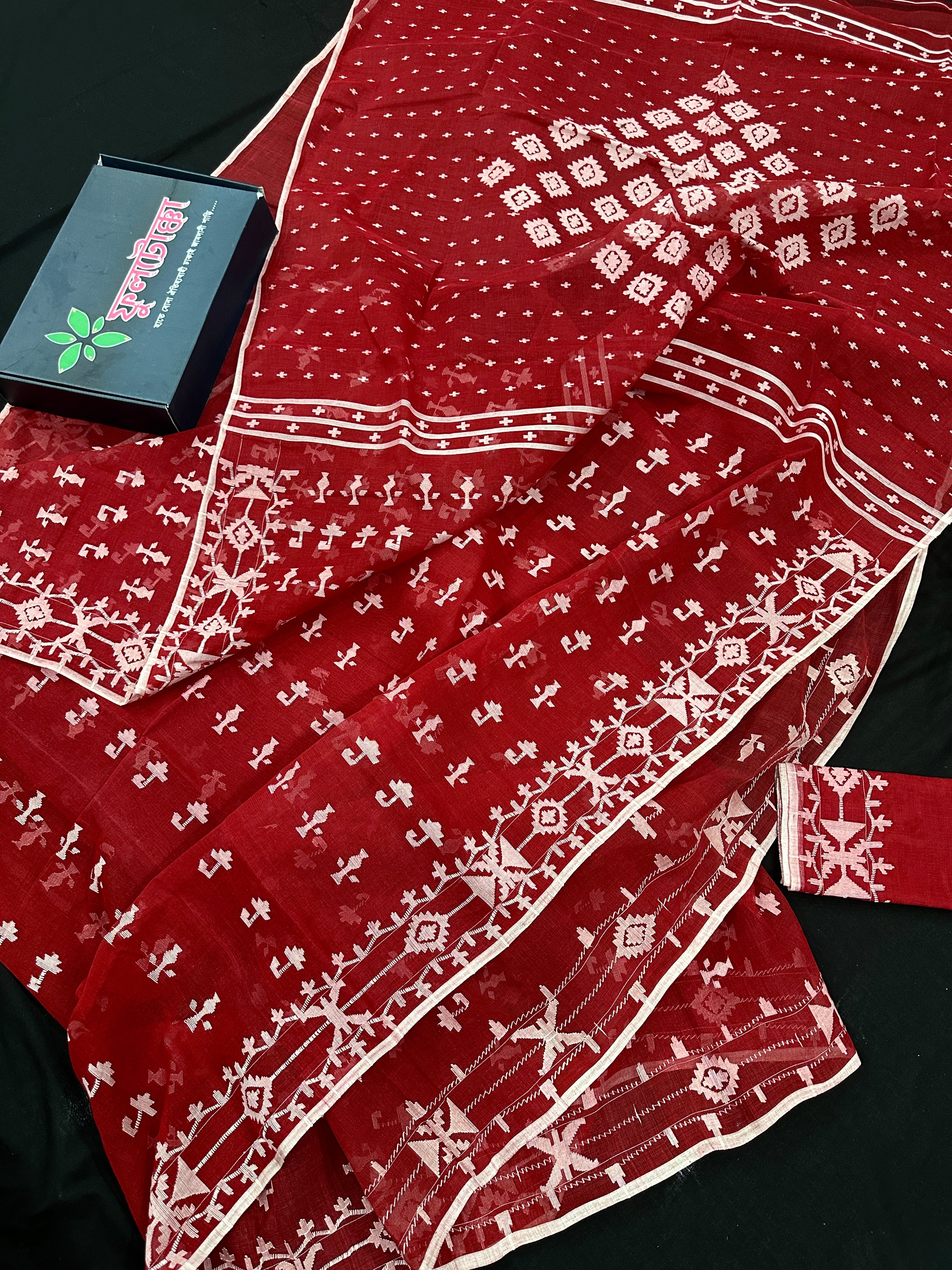 Maroon jamdani saree with white thread work.