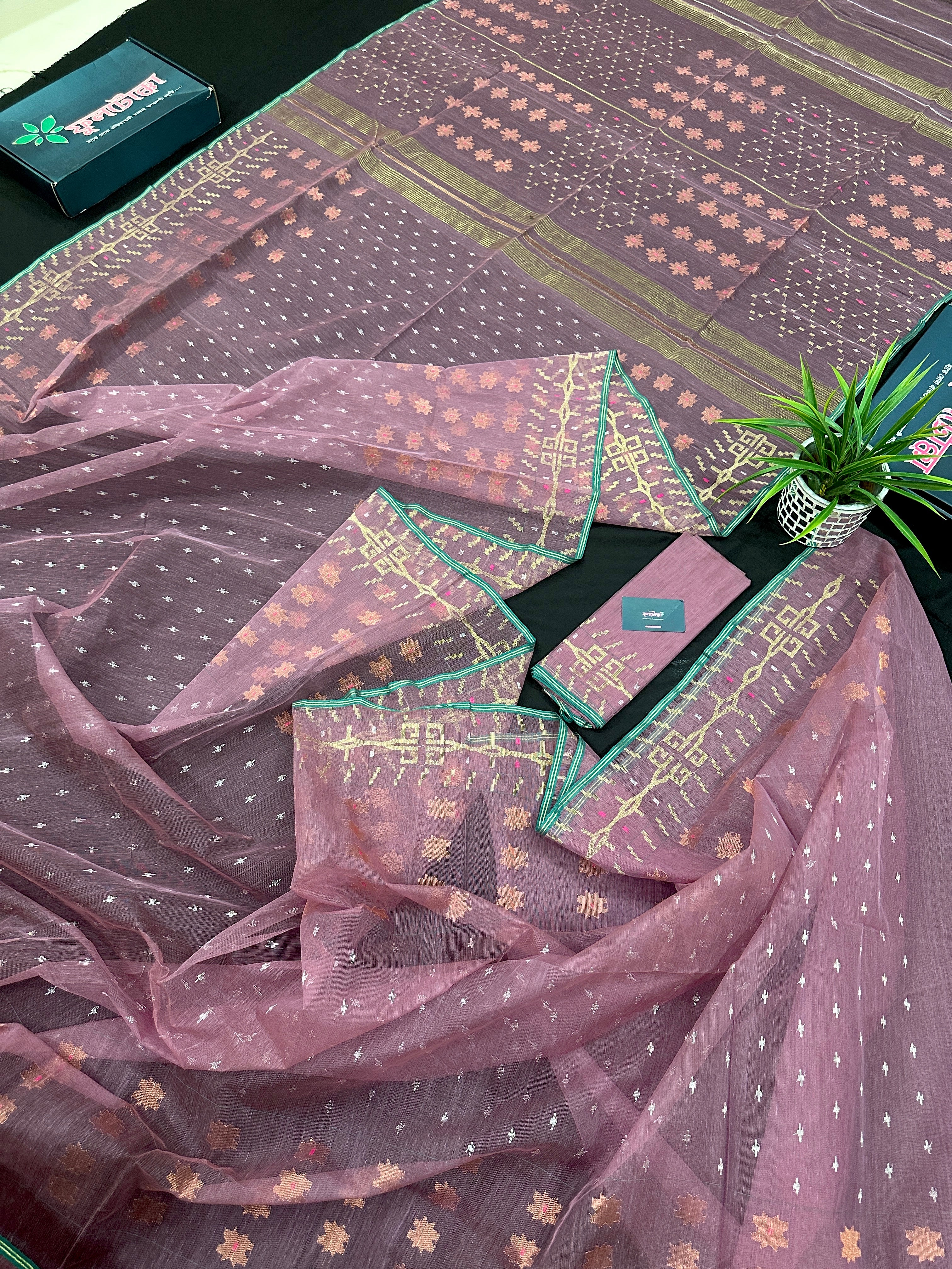 Onion colour jamdani saree with pink meena and green border.
