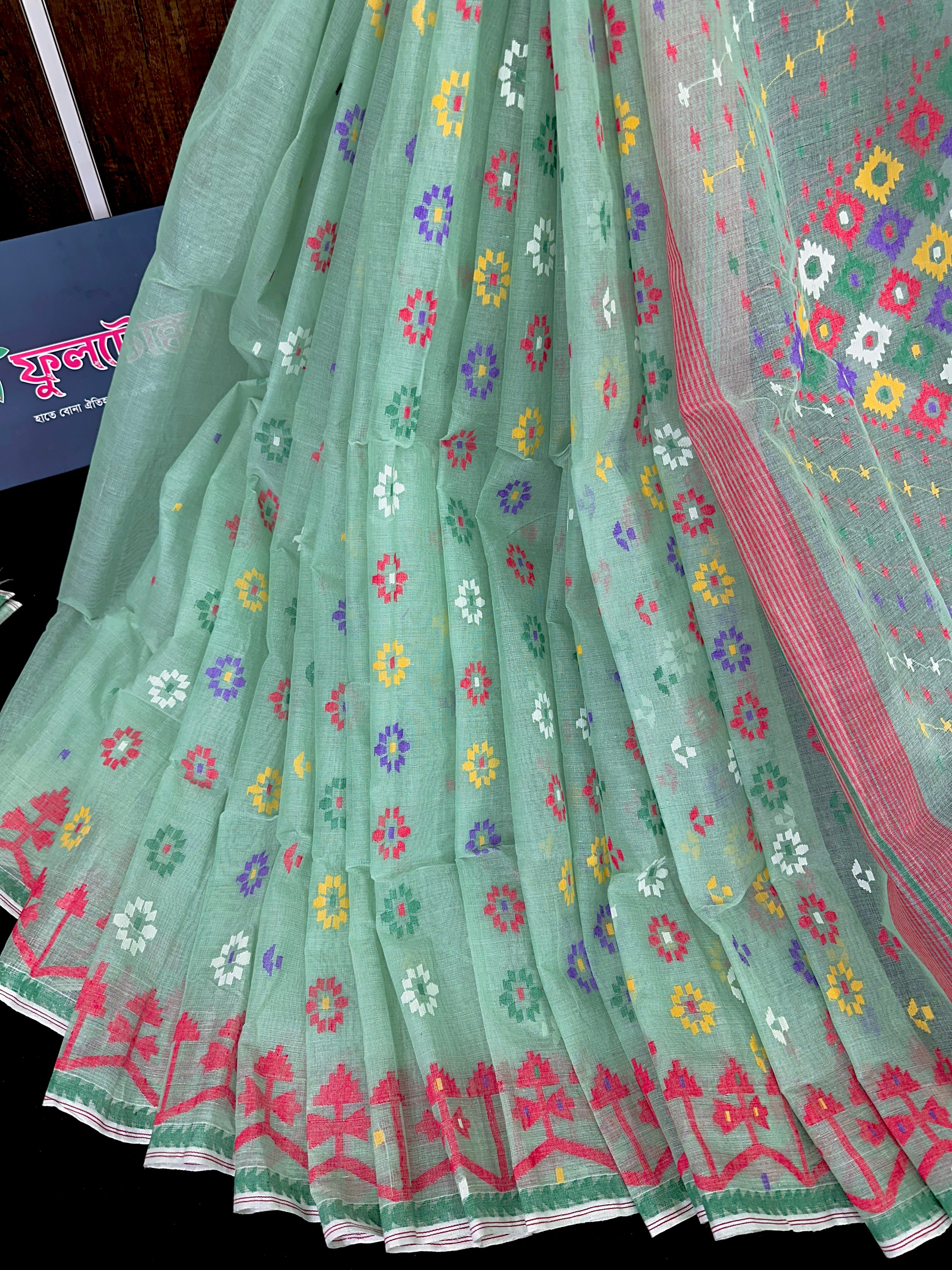 Mint cotton jamdani saree with yellow blue purple red white floral work.