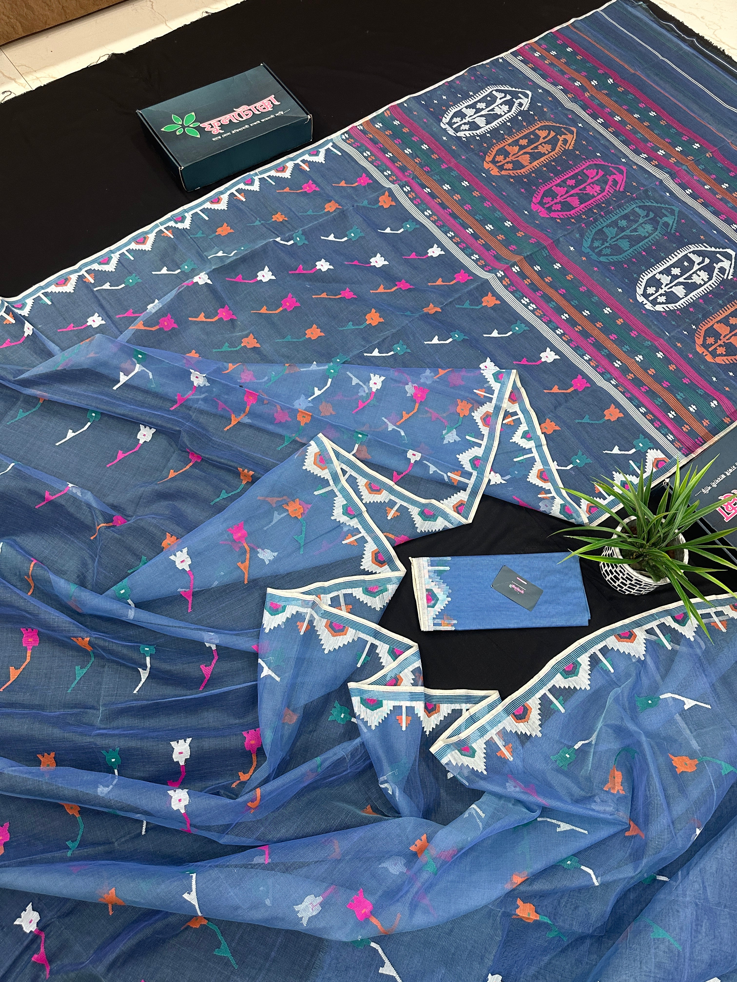 Dusty blue jamdani saree with pink white blue green work and white paar.